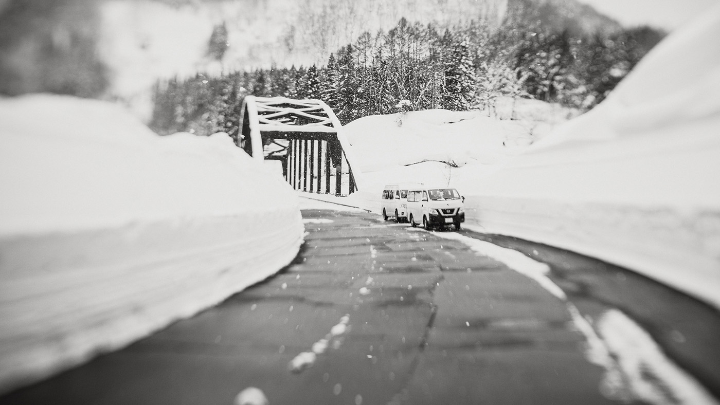 Street with snow on the sides and two vans